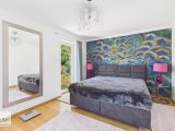Schlafzimmer mit Zugang zu Ankleide und Balkon