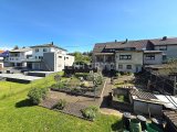 Rückansicht des Hauses mit vorderem Garten und Terrasse