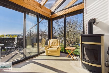 Wintergarten mit Kaminofen